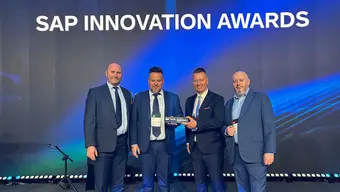 Image of four men posing for a photo with an award at SAP Innovation Awards