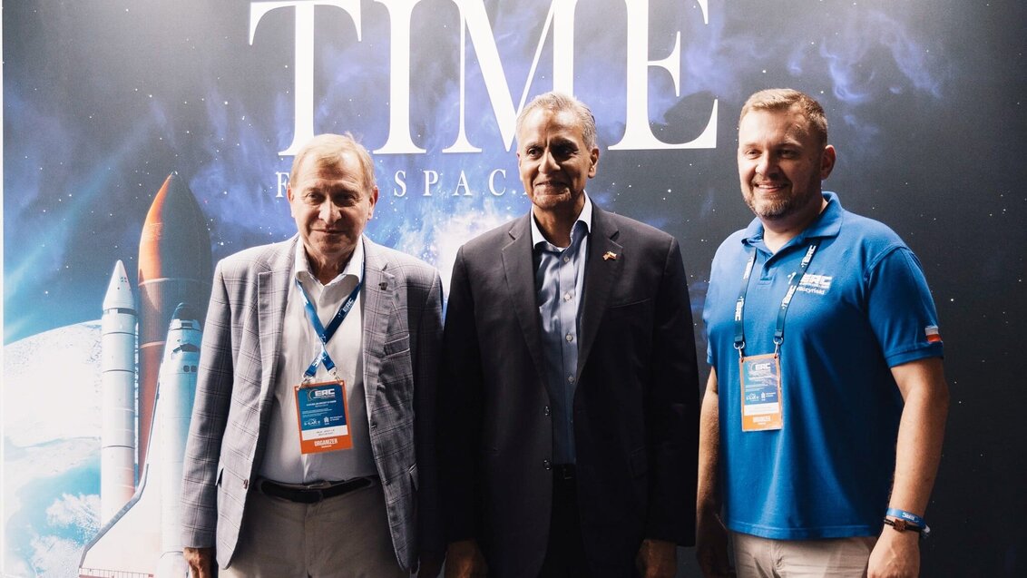 Image of three men standing in front of a space backdrop