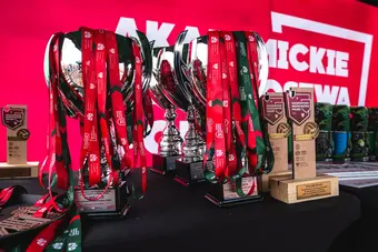 Image of a table with awards in a sports championships, cups filled with medals and statues