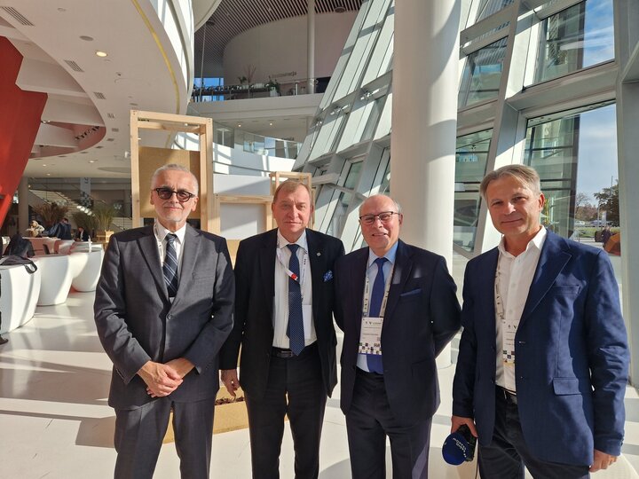 Image of four men standing inside the ICE Congress Centre