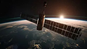 This image captures a satellite in space with the Earth and a sunrise or sunset in the background.