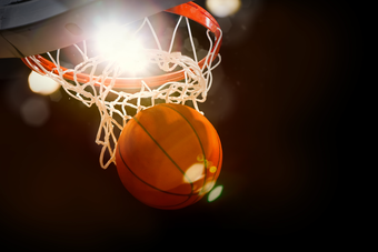 Image of a basketball being thrown into the basket