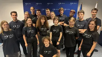 Image of a group of students wearing the same shirts with the logo of the Polish Space Agency