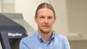 Image of a man in a blue shirt with short sleeves