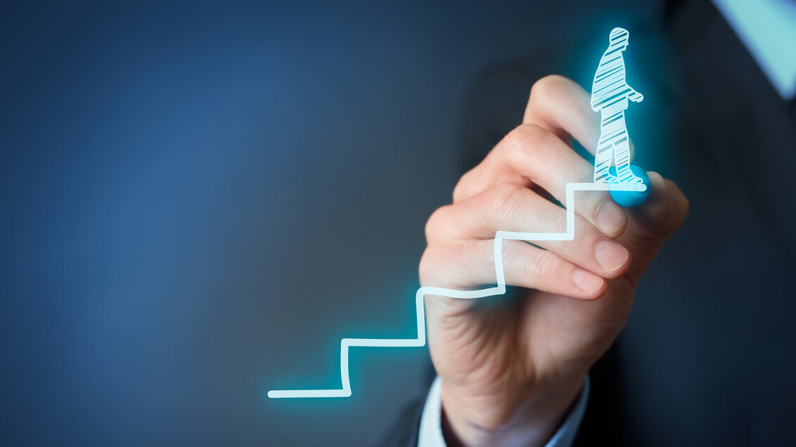 Abstract image of a person drawing a small character walking up the stairs in the air with their hand 